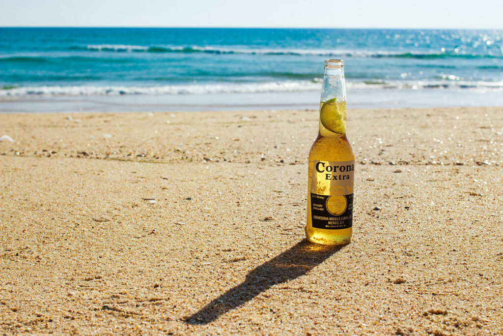 An image of a Corona beer on the beach that is properly sized to demonstrate how to optimize images for websites.